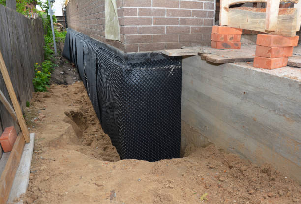 Happy homeowners after waterproofing job in Evart